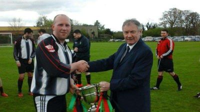 Marc O'Lone receiving the McDowell Cup from Alan Buchanan