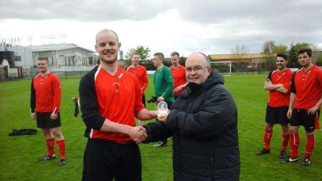 Man of the Match Stephen Downey receiving his trophy from Police Federation CEO George Clarke