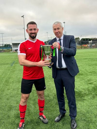 Phil Neill receiving the Buckley Cup from Chief Constable John Boucheron behalf of Armagh & Down