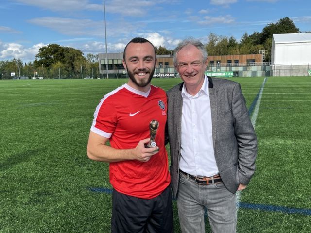 Joel Richardson receiving his Man of the Match trophy from League Vice Chairman Alan Buchanan