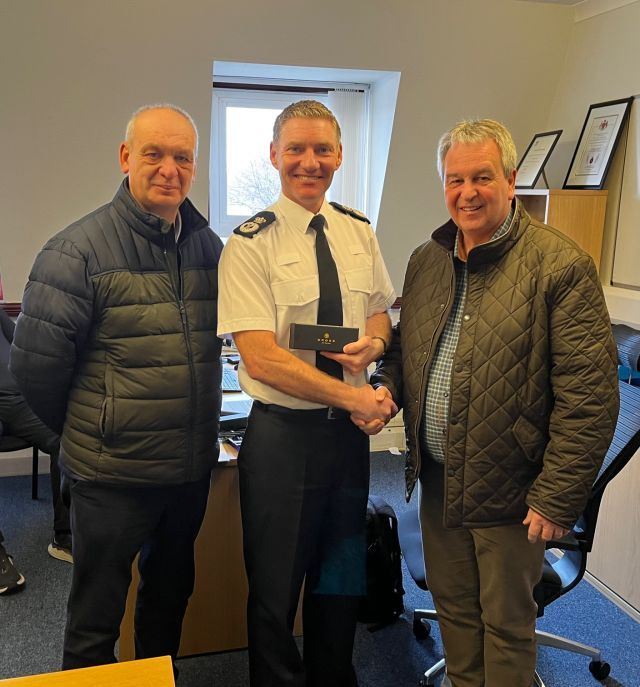 Members from Ballymoney Council presenting a small momento to the Chief Constable IofM Police