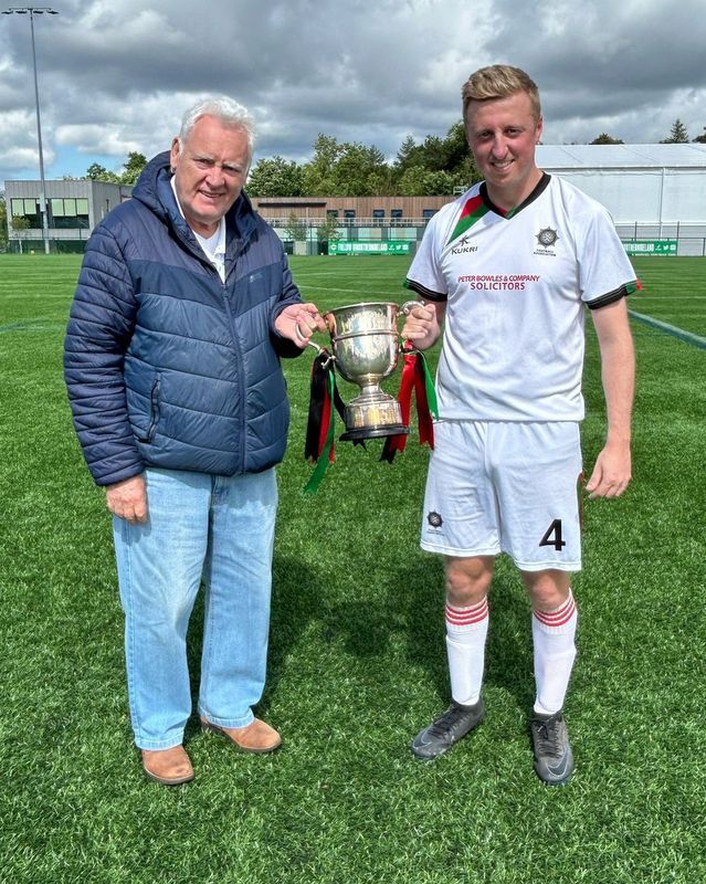 Belfast South/East captain Chris Boyd receiving the McDowell Cup from League Secretary Ivan Bell
