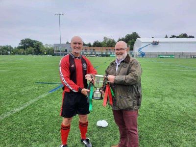 TSG captain Jeremy Dale receiving the McDowell Cup from Police Federation CEO George Clarke