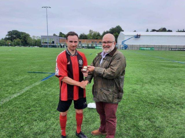 Man of the Match Mark Anderson receiving his trophy from Police Federation CEO George Clarke