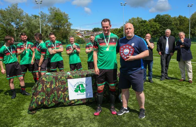 Phil Fitzsimmons receiving his PSNI managers player of the tournament trophy from Johnnie McKeever